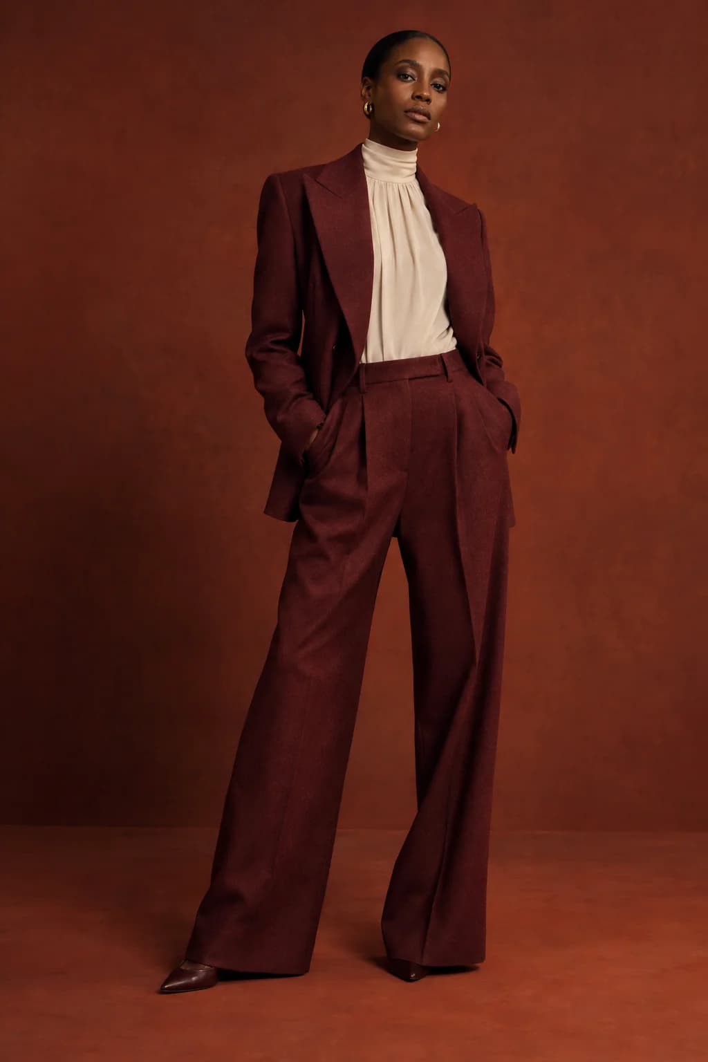 Tailoring campaign with a burgundy outfit and editorial lighting